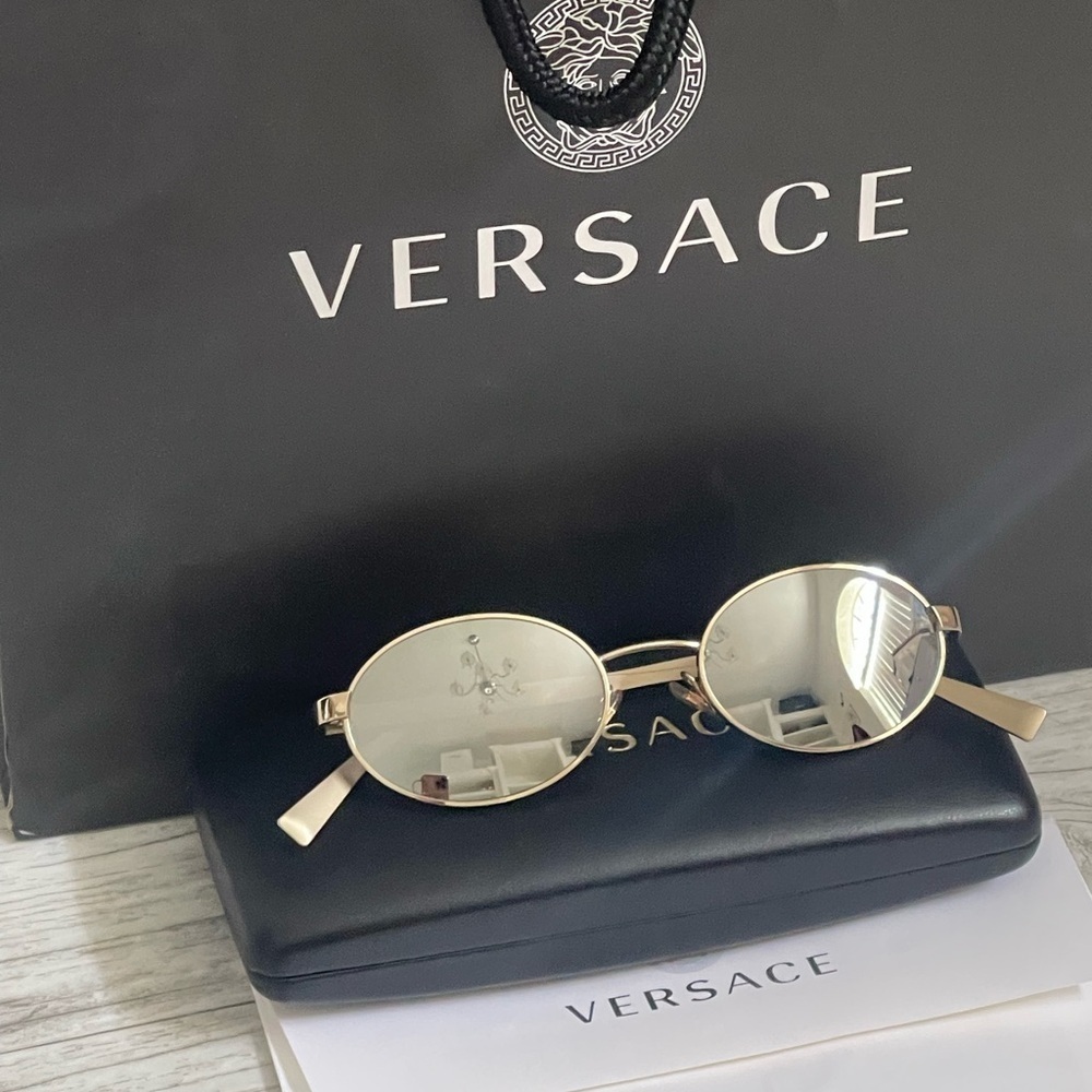 Beautiful  Versace Sunglasses feature mirrored silver lenses and gold rim.